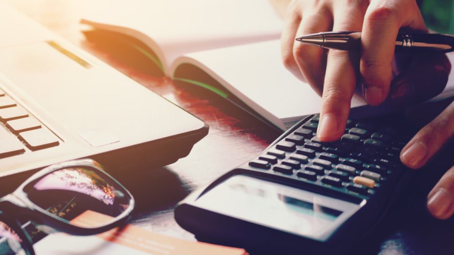 Close up woman doing finance with calculate expenses.